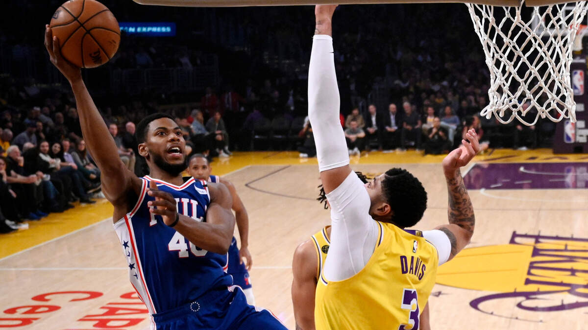 Philadelphia 76ers forward Glenn Robinson III, left, shoots as Los Angeles Lakers forward Anthony Davis defends during the first half of an NBA basketball game Tuesday, March 3, 2020, in Los Angeles. (AP Photo/Mark J. Terrill)
