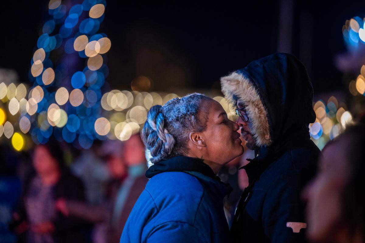 Erika Ard and James Jones, visiting from Douglasville, Ga., snuggle at the New Year’s Eve celebration on K Street in Old Sacramento on Tuesday night.