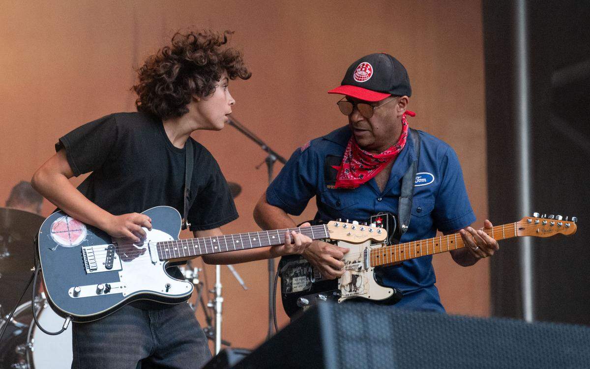 Roman Morello, left, plays guitar with his father musician-activist Tom Morello, formerly of Rage Against the Machine, during at the Aftershock festival in Sacramento’s Discovery Park on Sunday.