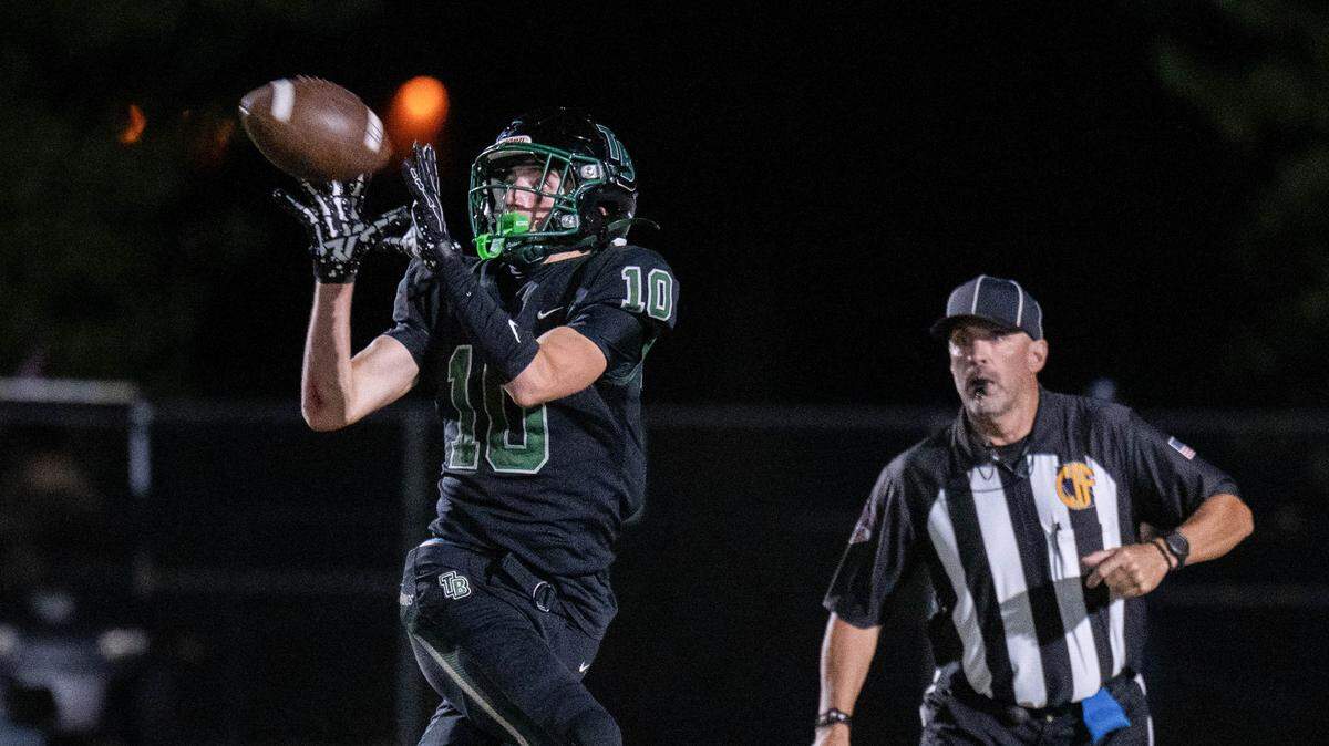 Dylan Amos (10) of the Twelve Bridges Raging Rhinos catches a touchdown pass in the first half against the Placer Hillmen on Friday, Oct. 10, 2025, in Roseville.