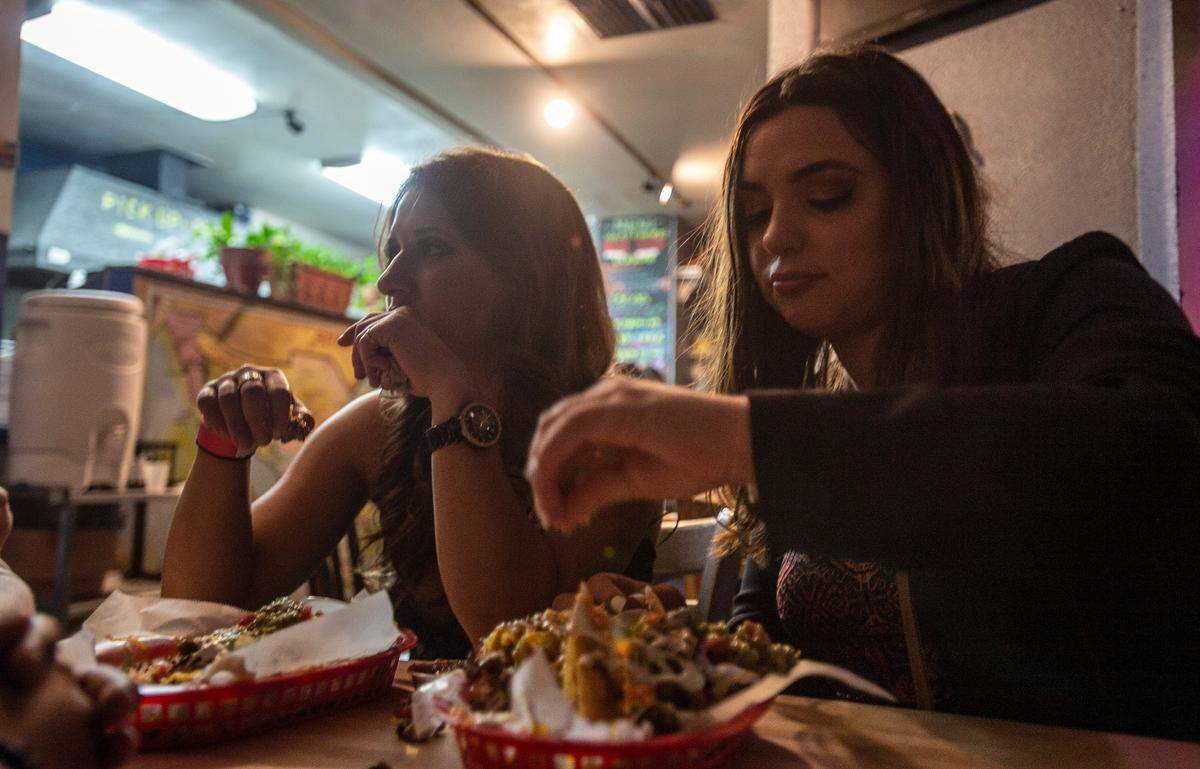 Nikki Garabaldi, right, and Alexandra Lyons eats nachos at Chitas, Saturday, October 6, 2018.