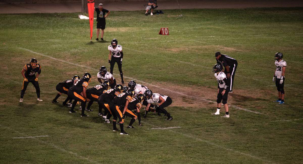 The Delta Saints line up against the Valley Christian Lions in a double wing formation during an 8-man football game in Clarksburg on Friday. It was the first night of 8-man football in the Sac-Joaquin Section.