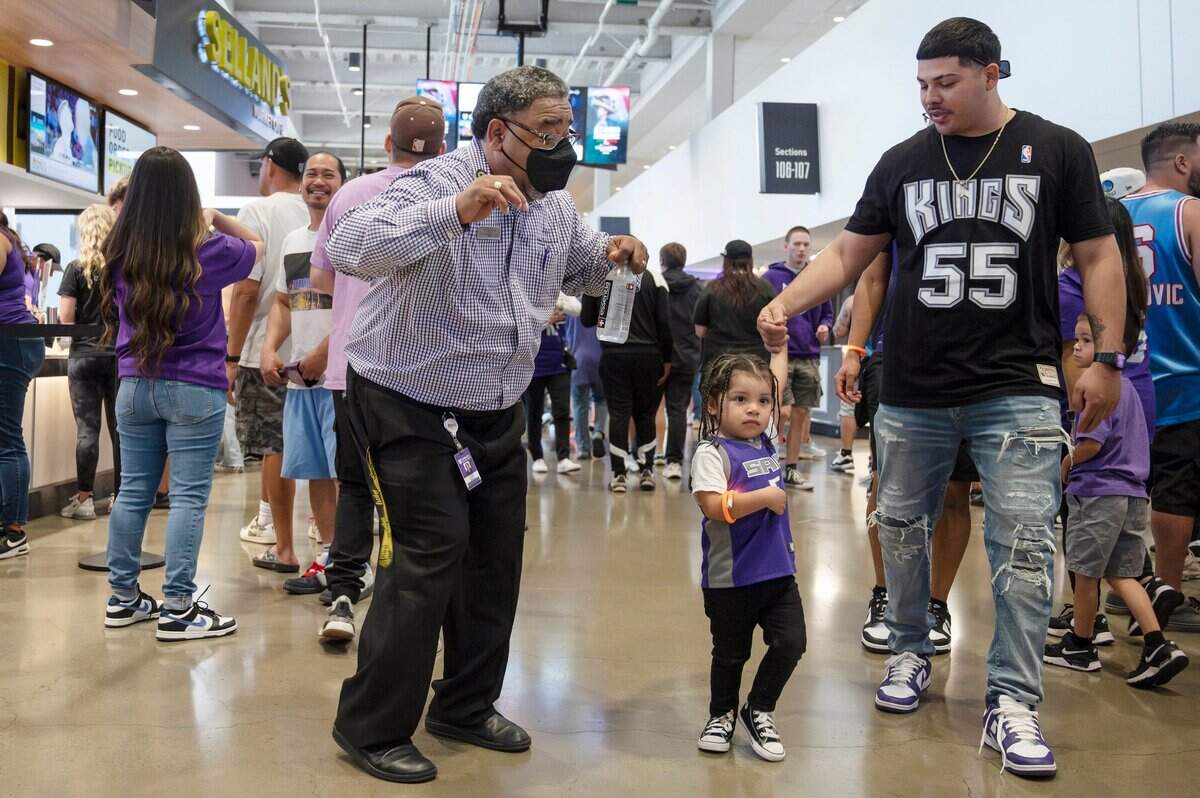 Kings’ ambassador Lee Smith, center, dances with fans as they walk the concourse at the Game 4 watch party at Golden 1 Center on Sunday.