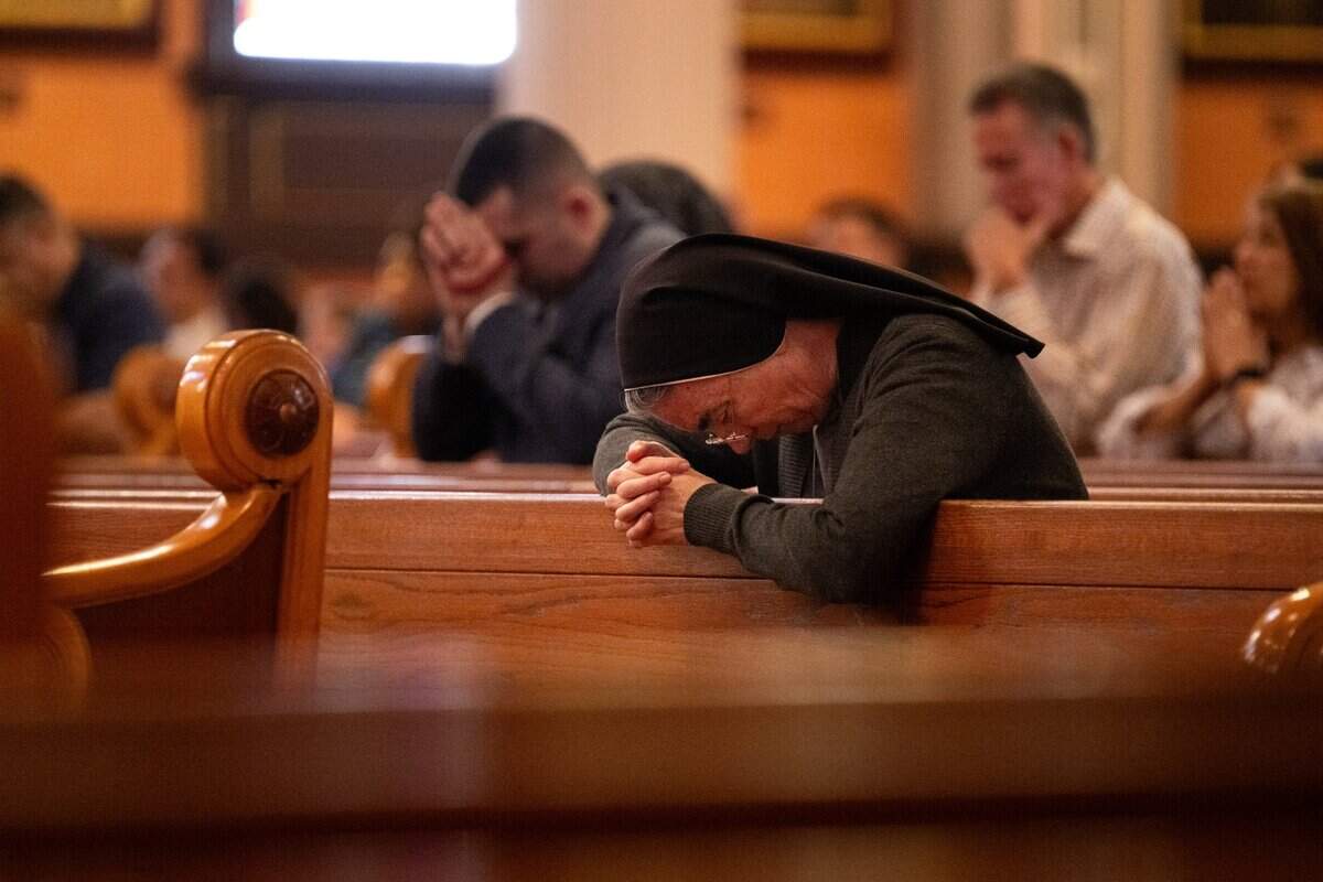 Sister Lisa Marie Doty of the Canossian Sisters prays as Father Michael O’Reilly gives the noon mass on Monday at the Cathedral of the Blessed Sacrament in Sacramento after the passing of Pope Francis.