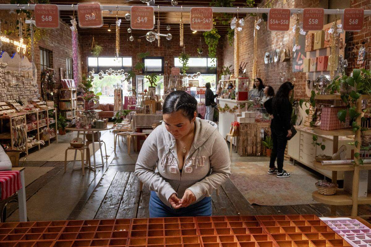 Nayeli Anedazola returns charms to boxes after creating a necklace at Golden Hour Designs in Oak Park on Tuesday, March 31, 2026.