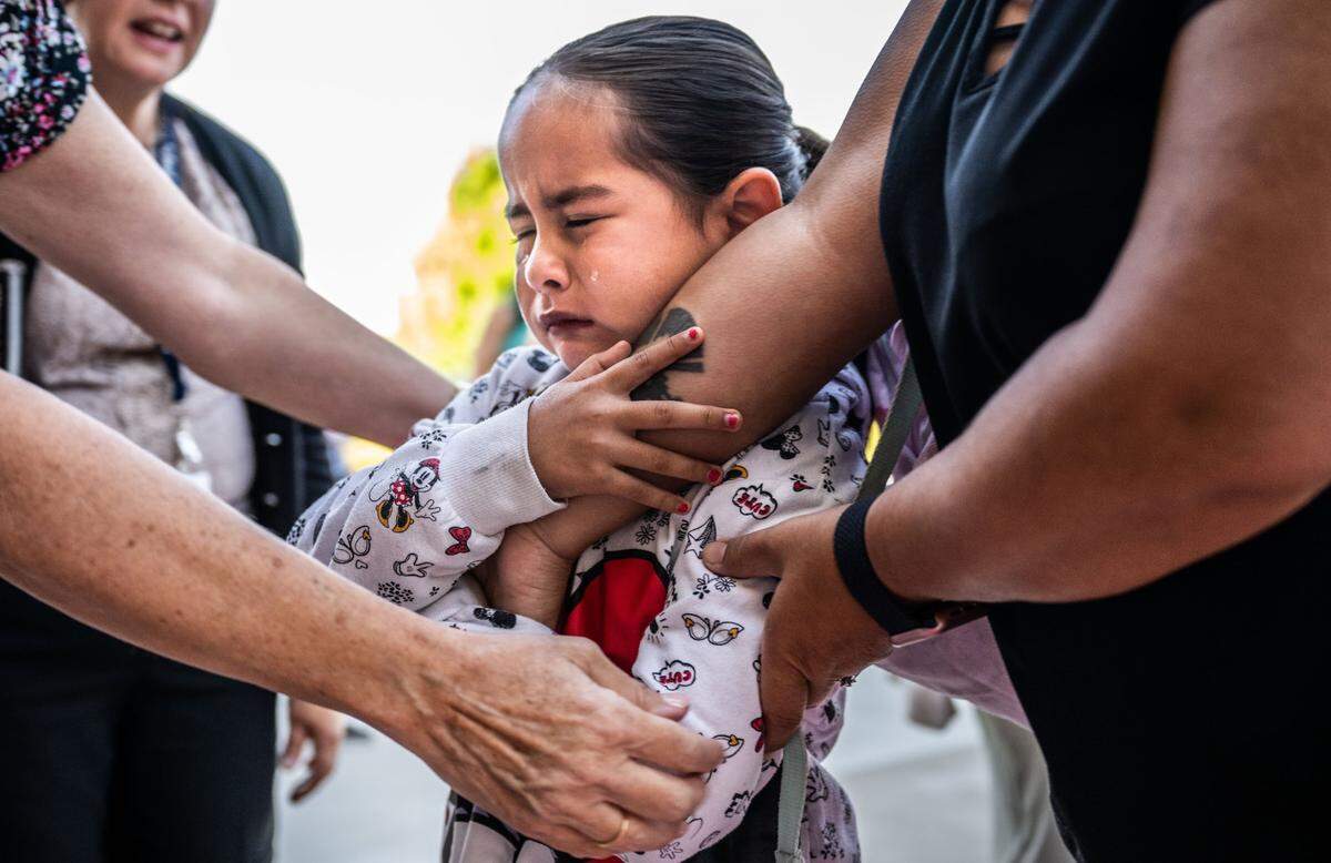 Eliana, a student at Navigator Elementary, sheds a tear as she leaves her family on the first first day of school Tuesday. Students were greeted with a red carpet welcome by staff and principal James Tucker in front of the Rancho Cordova school.