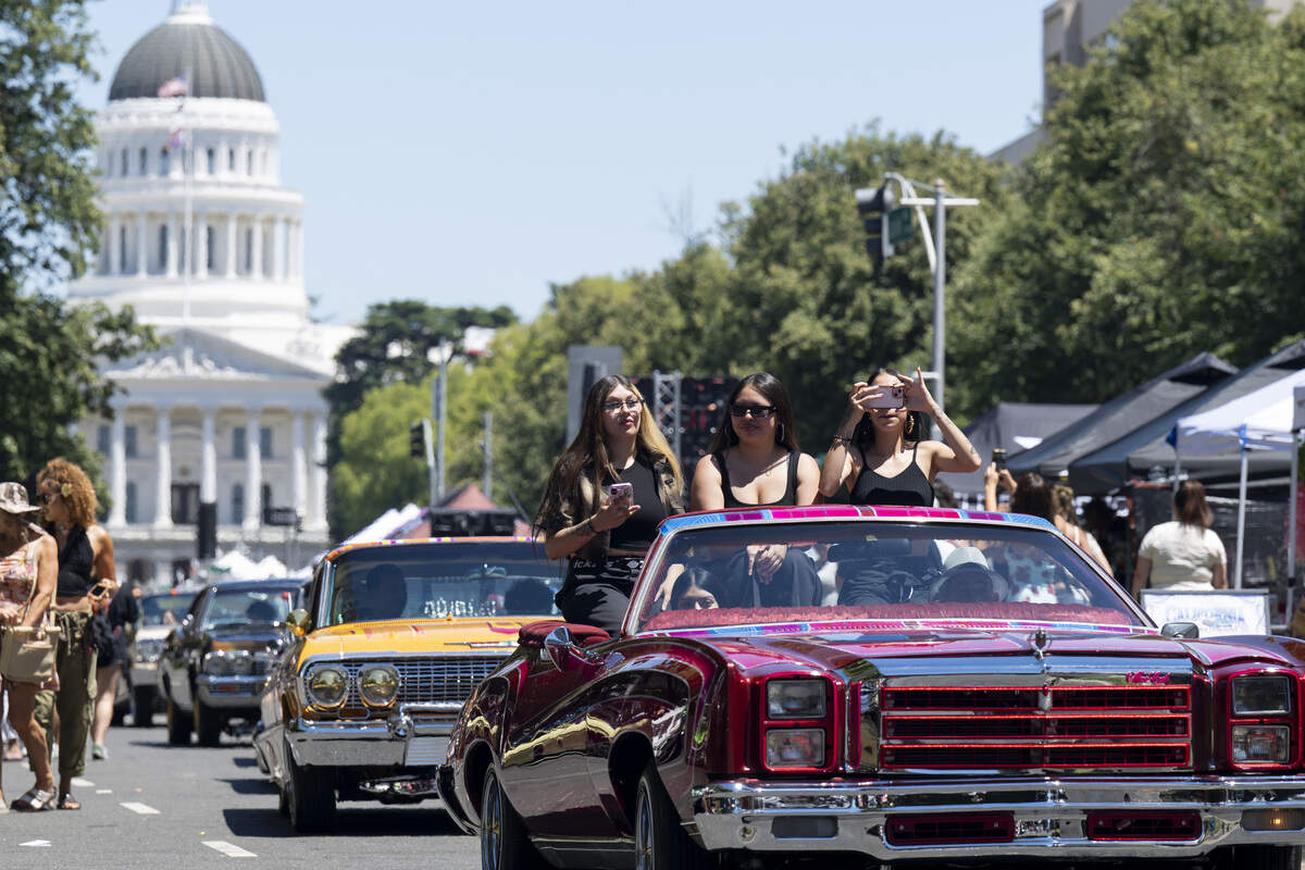 Lowriders cruise along Capitol Mall during the fourth annual Lowrider Holiday Celebration in Sacramento on Sunday, June 21, 2026.