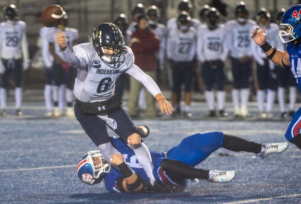 The Folsom Bulldogs’ Logan Hutton (6) tackles the Inderkum Tigers’ Ricky Cole (6) in the first half of a CIF Sac-Joaquin Section semifinal playoff game on Friday. 