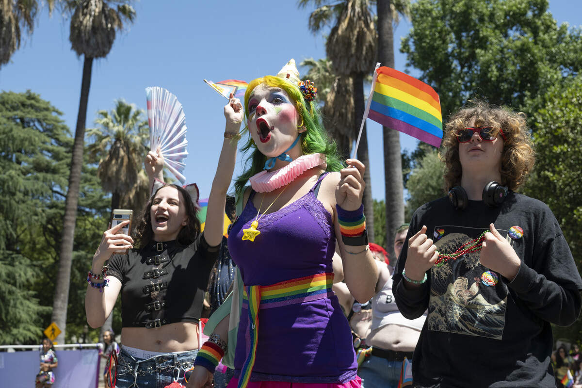 Jordan Ericksen, center, Zoey Thompson, left, and Parker Morgan react to a performer during the Sacramento Pride Parade in Sacramento on Sunday, June 14, 2026.