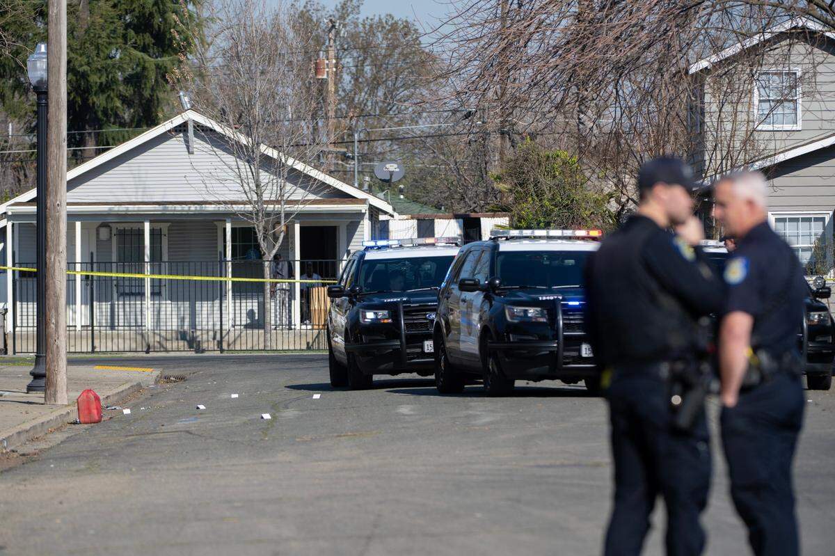 Sacramento Police officers investigate a shooting on Cantalier Street and El Camino Avenue in North Sacramento on Thursday.
