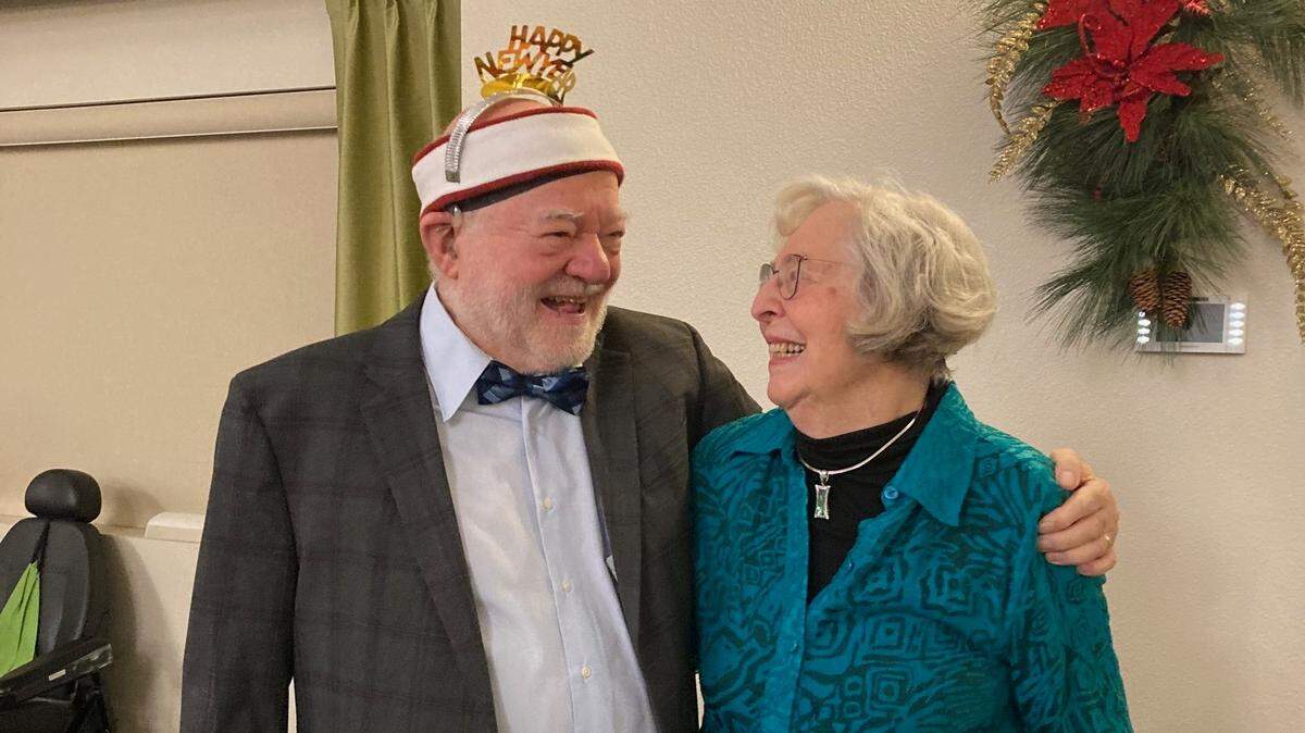 Wolfgang Hoppe, left, wraps his arm around Colene Sawyer Schlaepher, right.