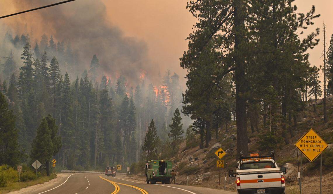 The Caldor Fire burns high in the trees near Camp Sacramento along Highway 50 on Sunday, Aug. 29, 2021.