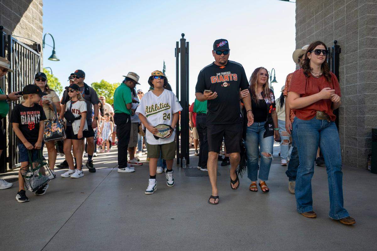 Athletics and San Fransisco Giants fans pass through the gates at Sutter Health Park on Friday, July 4 2025, before the teams play in West Sacramento for the first time.