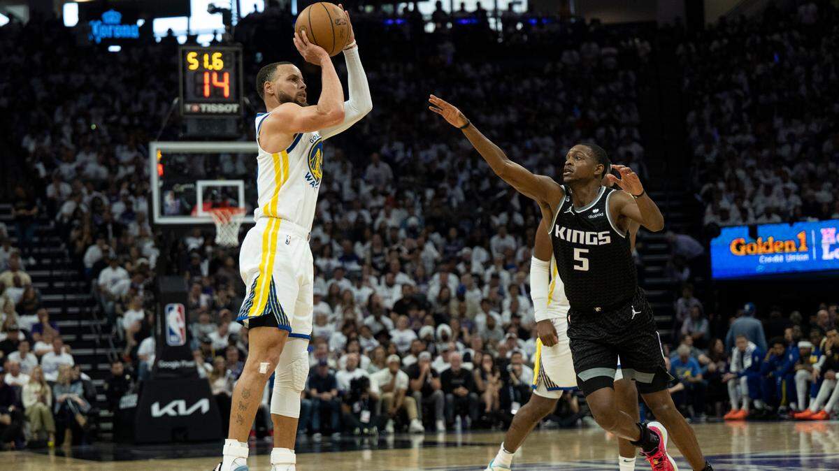 Golden State Warriors guard Stephen Curry (30) shoots three-point basket over Sacramento Kings guard De’Aaron Fox (5) during Game 1 of the first-round NBA playoff series at Golden 1 Center on Saturday, April 15, 2023.