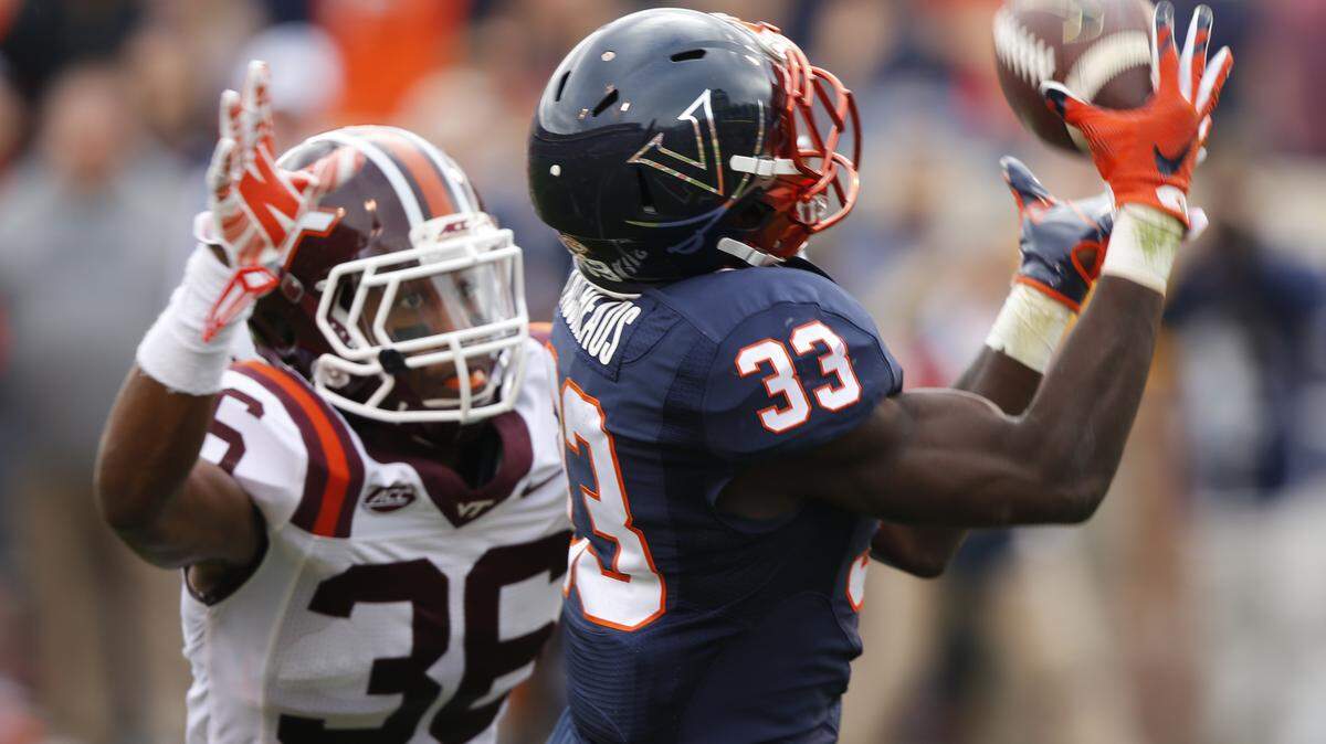 FILE This Saturday Nov. 28, 2015 file photo shows Virginia running back Olamide Zaccheaus (33) as he hauls in a pass as Virginia Tech Adonis Alexander (36) defends in Charlottesville, Va. The versatile junior is hoping a more focused approach will allow for a breakthrough season this year.