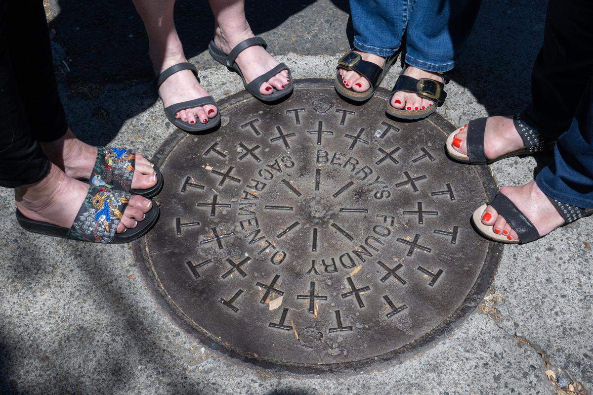 Descendants of the founder of Berry’s Foundry stand around a manhole cover from their great-grandfather’s Sacramento foundry earlier this month. 