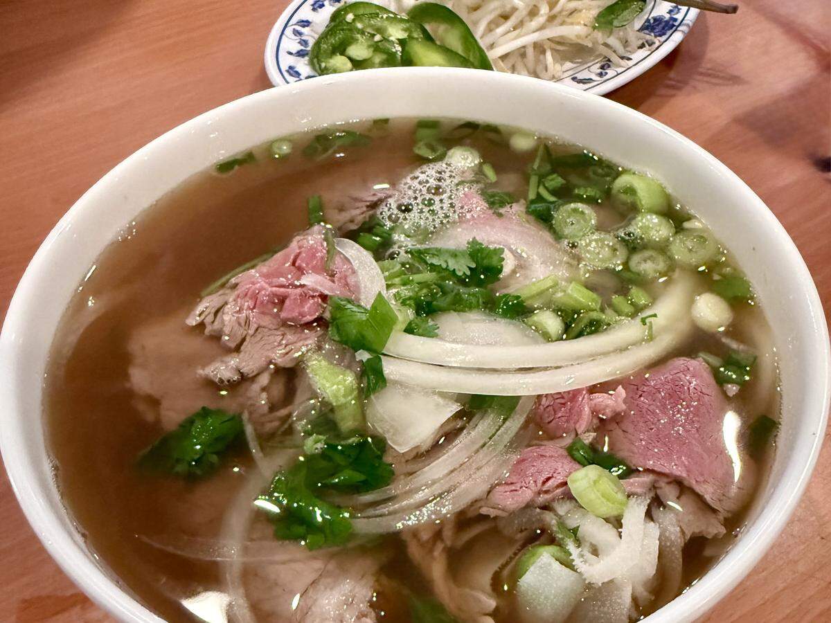 Pho City’s Pho DB Dac Biet Special with rare steak, meatball, brisket, flank, tendon and tripe over rice noodles.