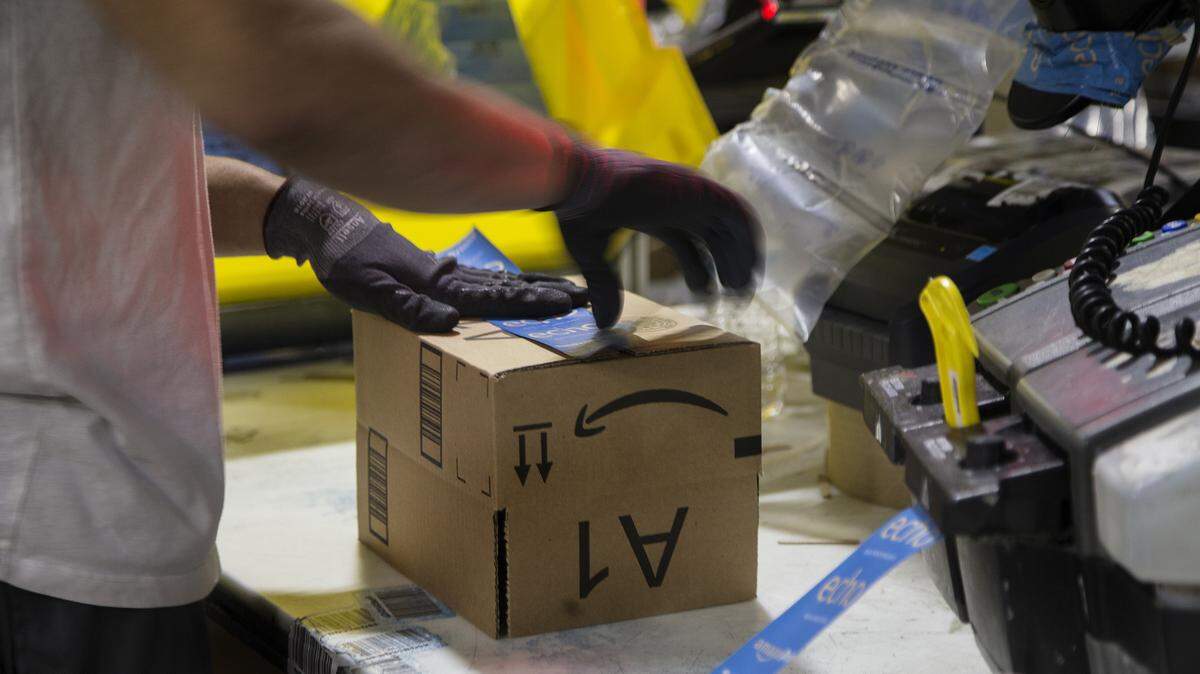 A worker packs a box on Cyber Monday in 2016 at the Amazon fulfillment center in San Bernardino. California’s next governor will have to guide the state through the fast-evolving economy.