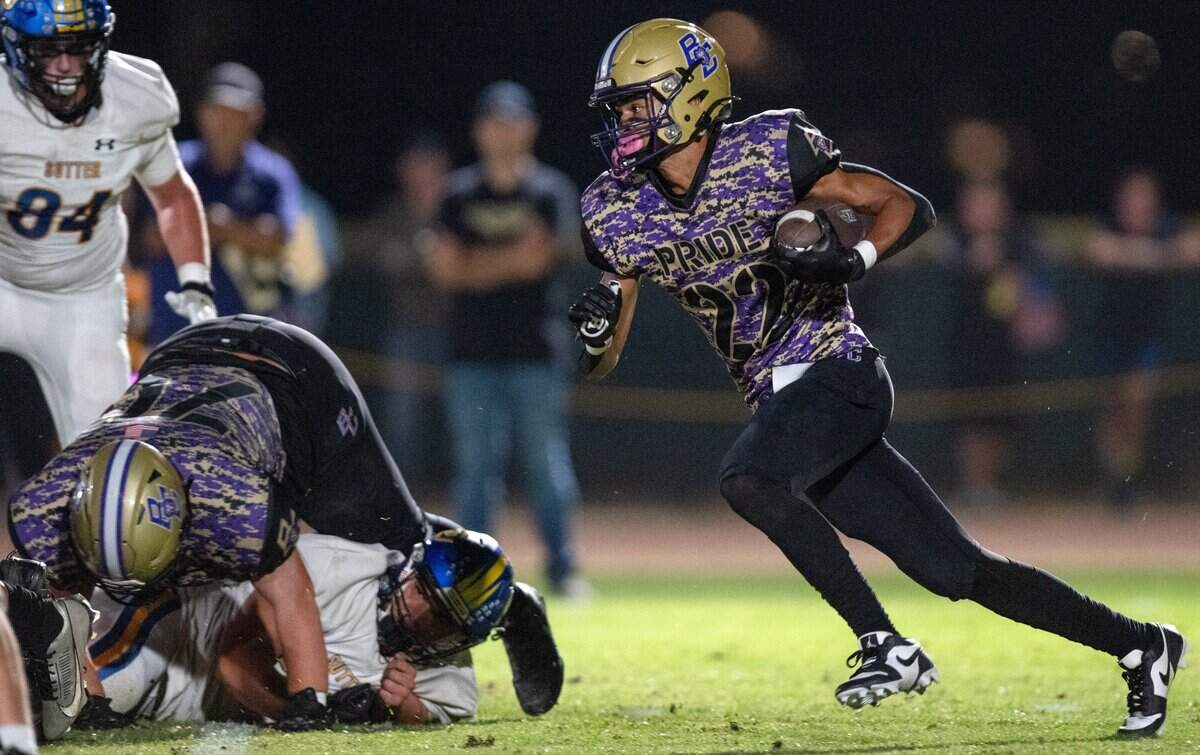 The Bradshaw Christian Pride's Bishop Porter (22) carries the ball for a second-half first down against the Sutter Huskies in Vineyard on Friday.