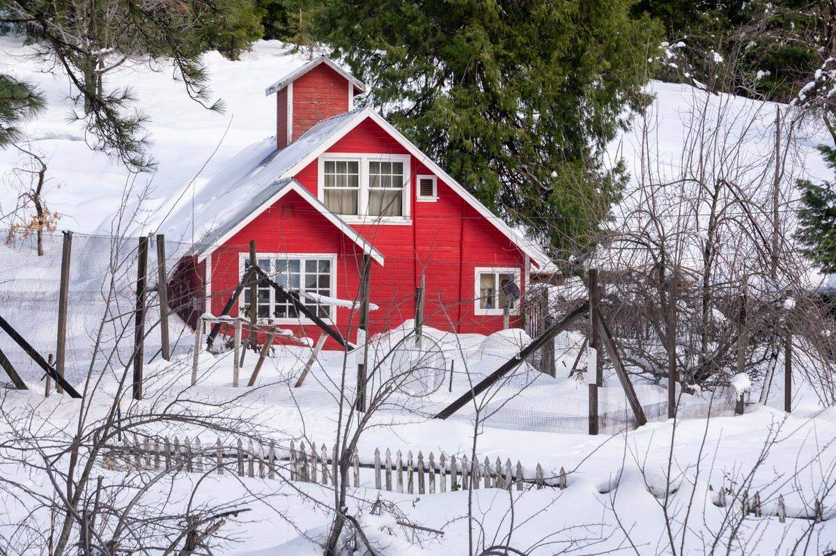 A home is covered in snow on Ridge Road in Dutch Flat on Tuesday.