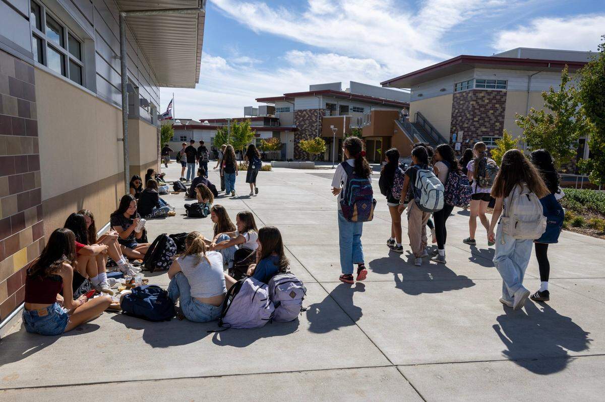 Students socialize during lunch at Sutter Middle School in Folsom on Thursday. The school has banned cell phones during school hours, including lunch, since 2022.