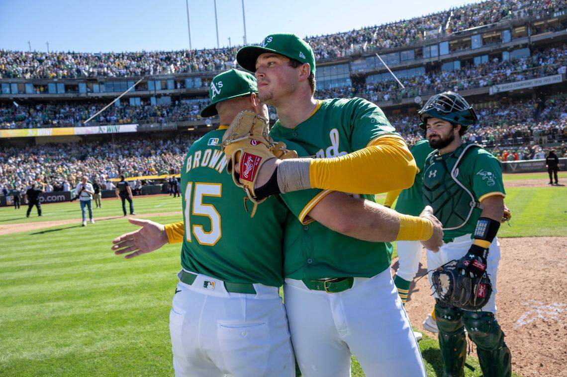 Oakland A’s pitcher Mason Miller congratulates first baseman Seth Brown after the team defeated the Texas Rangers in its final game at Oakland-Alameda County Coliseum on Thursday.