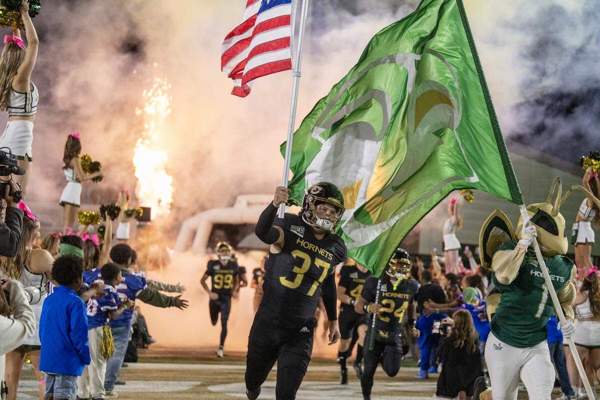 Sacramento State Hornets long snapper Connor McDowell (37) and Herky the Hornet lead the team onto the field during an October home game. Sacramento State is set to become the first California program in nearly 60 years to move to the FBS after accepting an invitation to join the Mid-American Conference.