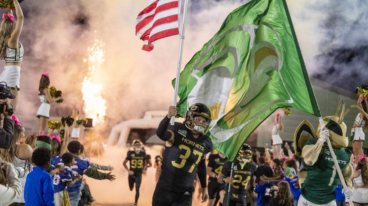 Sacramento State Hornets long snapper Connor McDowell (37) and Herky the Hornet lead the team onto the field before taking on the Montana Grizzlies on Friday, Oct. 24, in Sacramento.