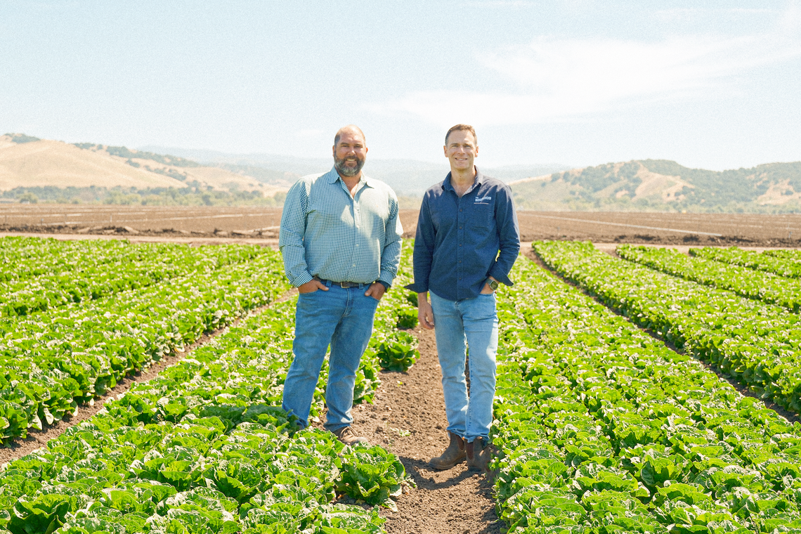 Brian Antle of Tanimura & Antle, the produce grower Reservoir Farms is collaborating with, (left) and Danny Bernstein of The Reservoir (right) stand on 40 acres of farmland in Salinas, Calif. This will become a living laboratory for the development, testing and demonstration of next generation agtech solutions.