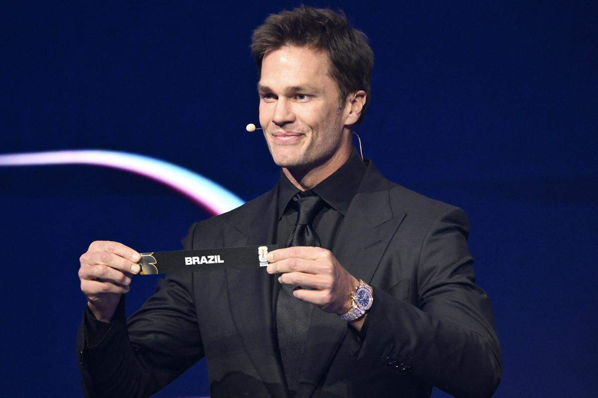 Draw assistant Tom Brady shows the card reading Brazil during the 2026 World Cup draw at the Kennedy Center, in Washington, D.C., on Friday.