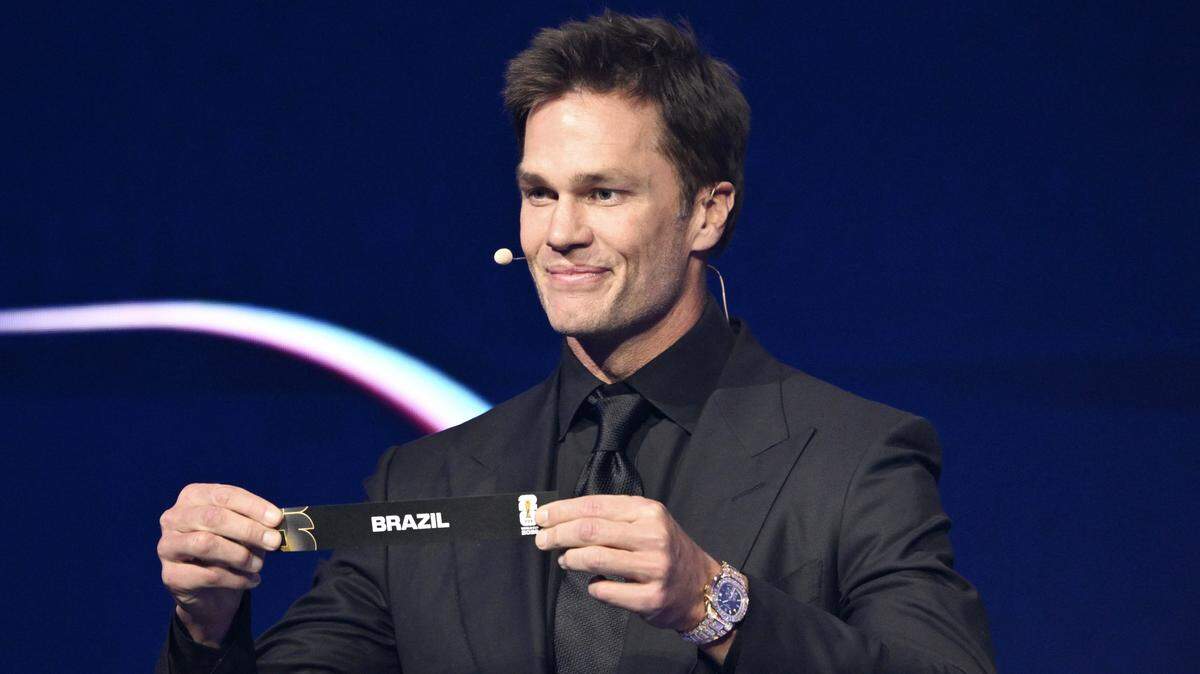 Tom Brady shows the card reading Brazil during the 2026 World Cup draw at the Trump-Kennedy Center in Washington, D.C., on Dec. 5. Brady is scheduled to appear Thursday at a public rally in downtown Sacramento to celebrate the opening of his sports memorabilia business, CardVault by Tom Brady.