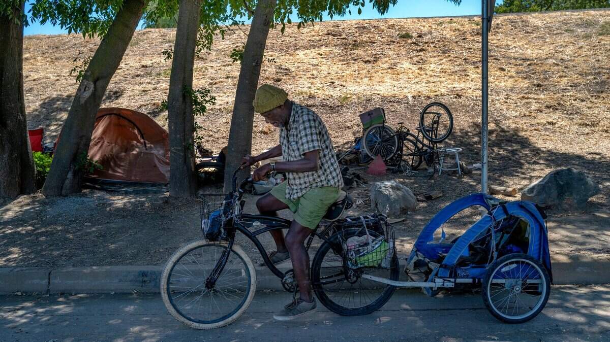 Eugene Williams, 63, rides his bike from his encampment on Lathrop Way in Sacramento to Loaves & Fishes for lunch, Friday, Aug. 12, 2022. He was trying to decide if it would be safe for him to move to the city of Sacramento Safe Ground for homeless at Miller Park. Do they have security there? Are they going to be smoking? Because I cant take smoking, said Williams who suffers from a variety of health issues.
