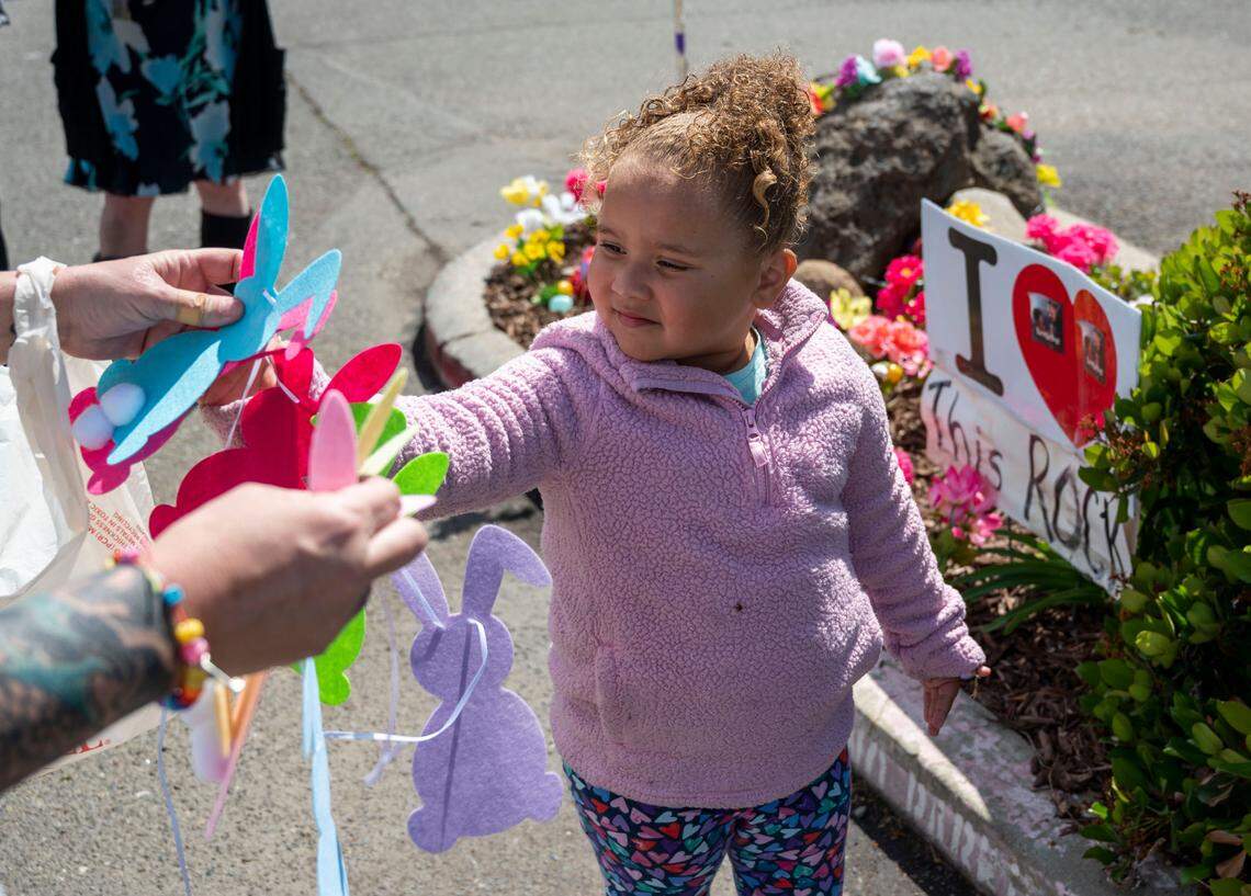 Ameera Owens, 3, is handed decorations to put around Rocky on April 16. Her parents live in Antelope and are Facebook fans of Rocky.