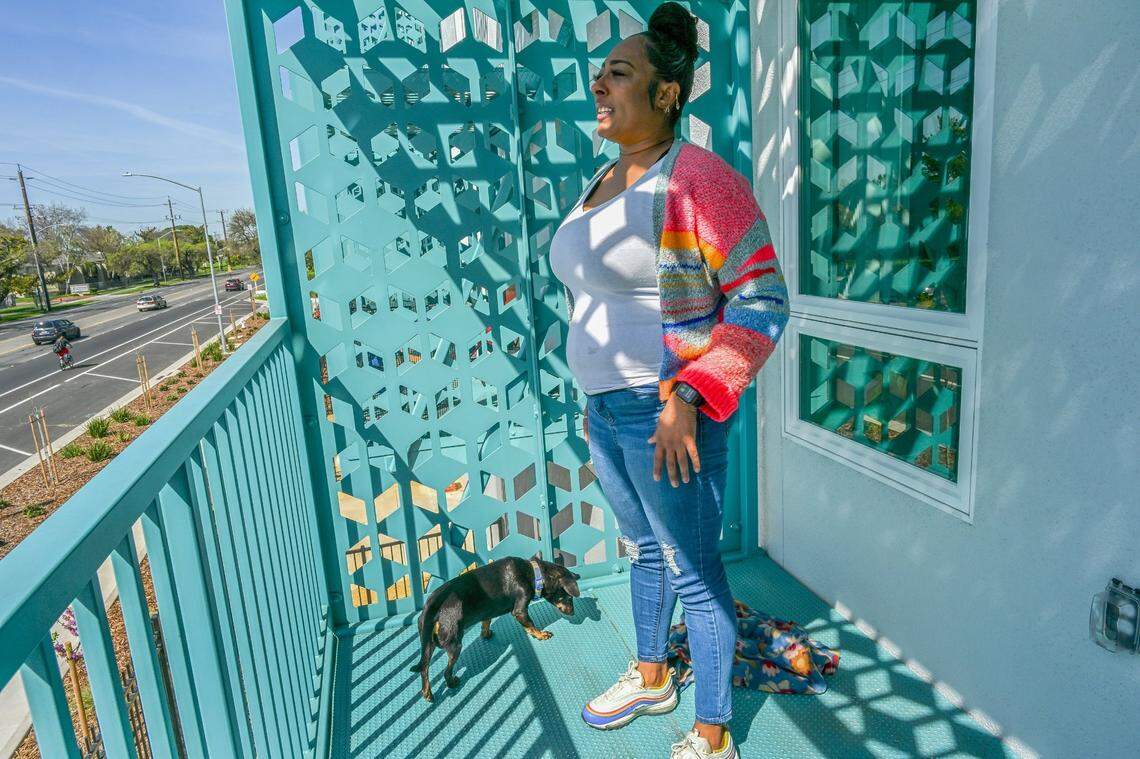 Shakela Wade stands on her balcony in March with her dog Scooter.