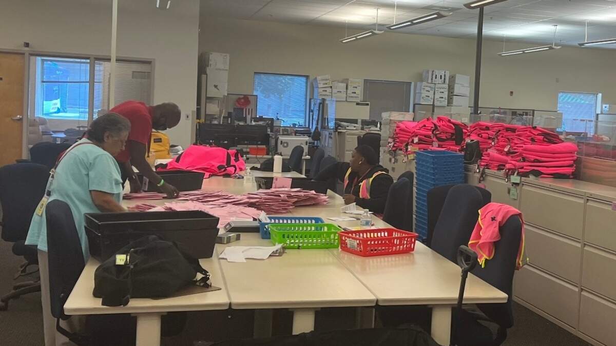 Election employees organize ballots and check signatures during the 2022 California primary on Tuesday June 7. 1,000 temporary employees facilitate ballot counting at the Sacramento County Voter Registration and Elections Office in South Sacramento.