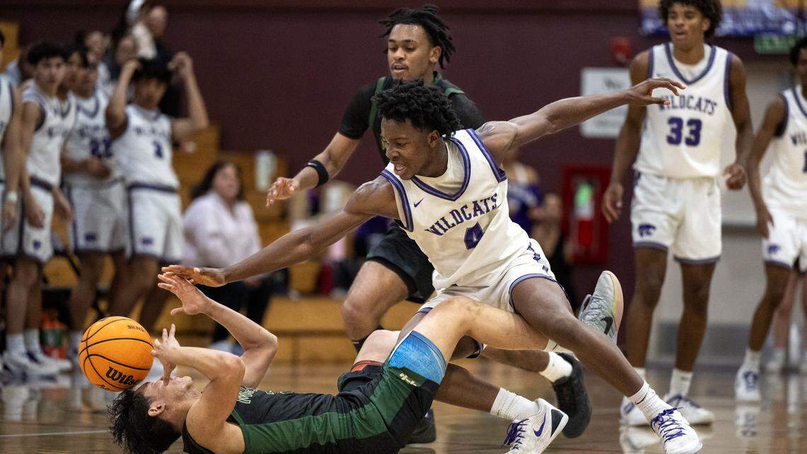 The Moreau Catholic Mariners' Clifford Brandon and the Franklin Wildcats' Benjamin Sandy chase after a loose ball in the second half Tuesday in the CIF Northern California Regional Division I boys basketball opener in Elk Grove.
