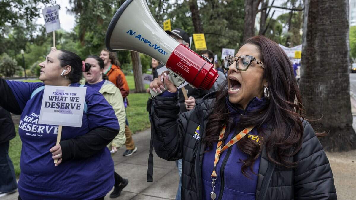 Anica Walls, president of SEIU Local 1000, leads a Sacramento march from Capitol Park to the CalHR building against Gov. Gavin Newsom's return-to-office mandate for state workers on Wednesday, April 22, 2026.