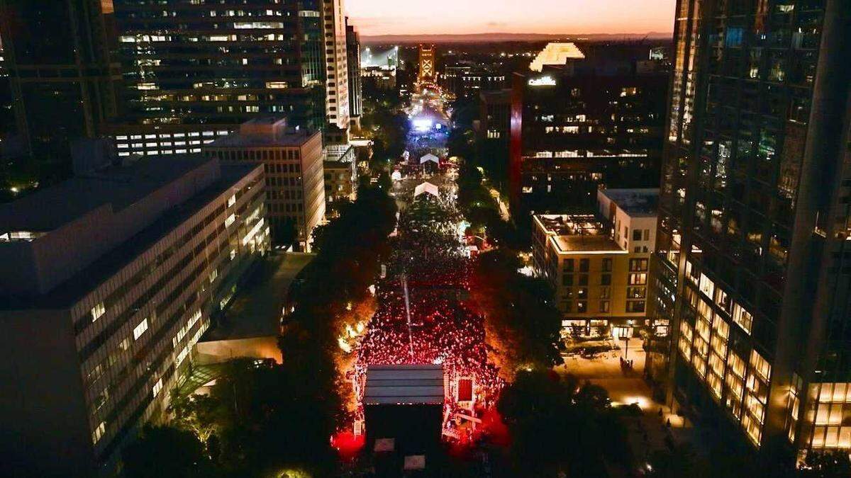 Crowds fill Capitol Mall in downtown Sacramento with the Tower Bridge visible in the background on Sunday, Sept. 1, 2025, during the two-day Jalo Fest. The inaugural Latin music festival drew thousands of attendees over Labor Day weekend and featured more than a dozen artists across two stages.