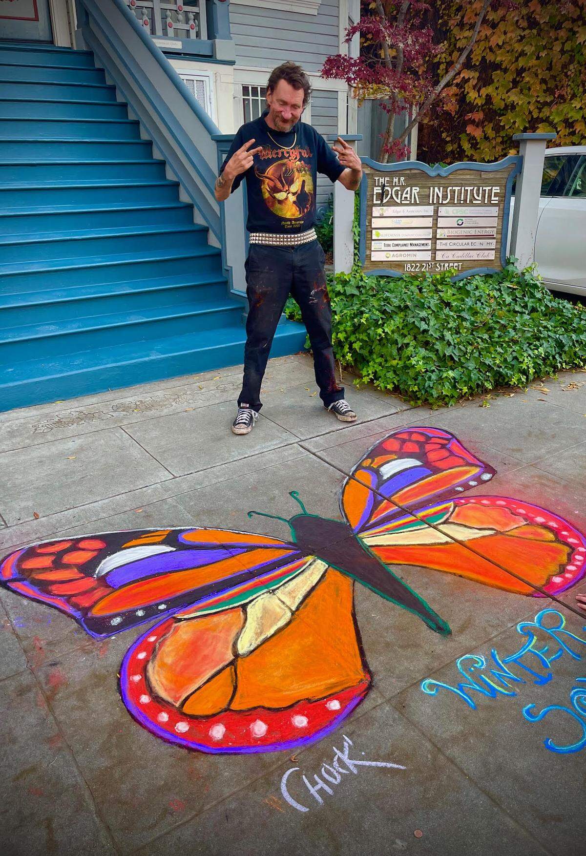 Charles “Ground Chuck” Thomas is pictured in December 2024 in Sacramento with his chalk-art creation.