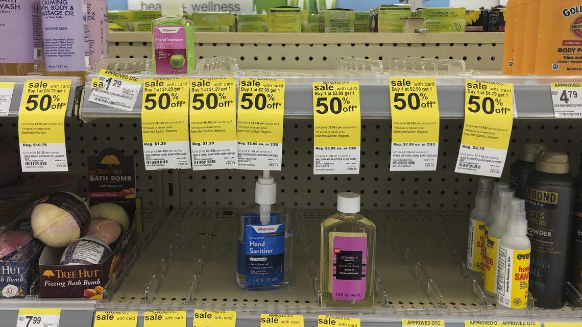 Only a few bottles of hand sanitizers remain on the shelves at a Walgreen Pharmacy, Friday, Feb. 28, 2020, in Miami Shores, Fla. Companies that make hand sanitizers and wipes are boosting production as they expect high demand for these products because of concerns of the spread of coronavirus. (AP Photo/Marta Lavandier)