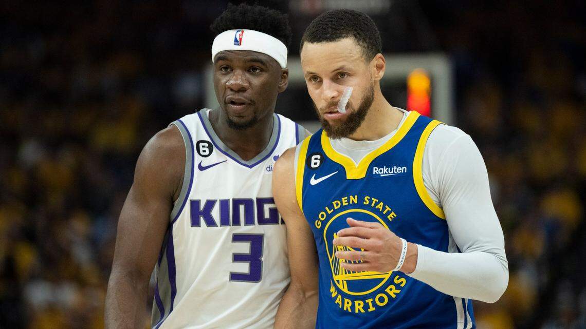 Golden State Warriors guard Stephen Curry (30) walks down court with Sacramento Kings guard Terence Davis II (3) during Game 6 of the first-round NBA playoff series at Chase Center on Friday, April 28, 2023.