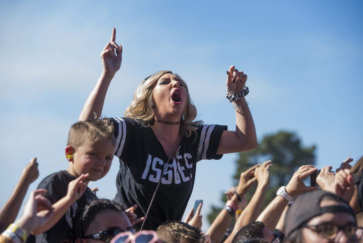 A fan enjoys the music of Issues during the Monster Energy Aftershock music festival at Gibson Ranch Regional Park in 2015.