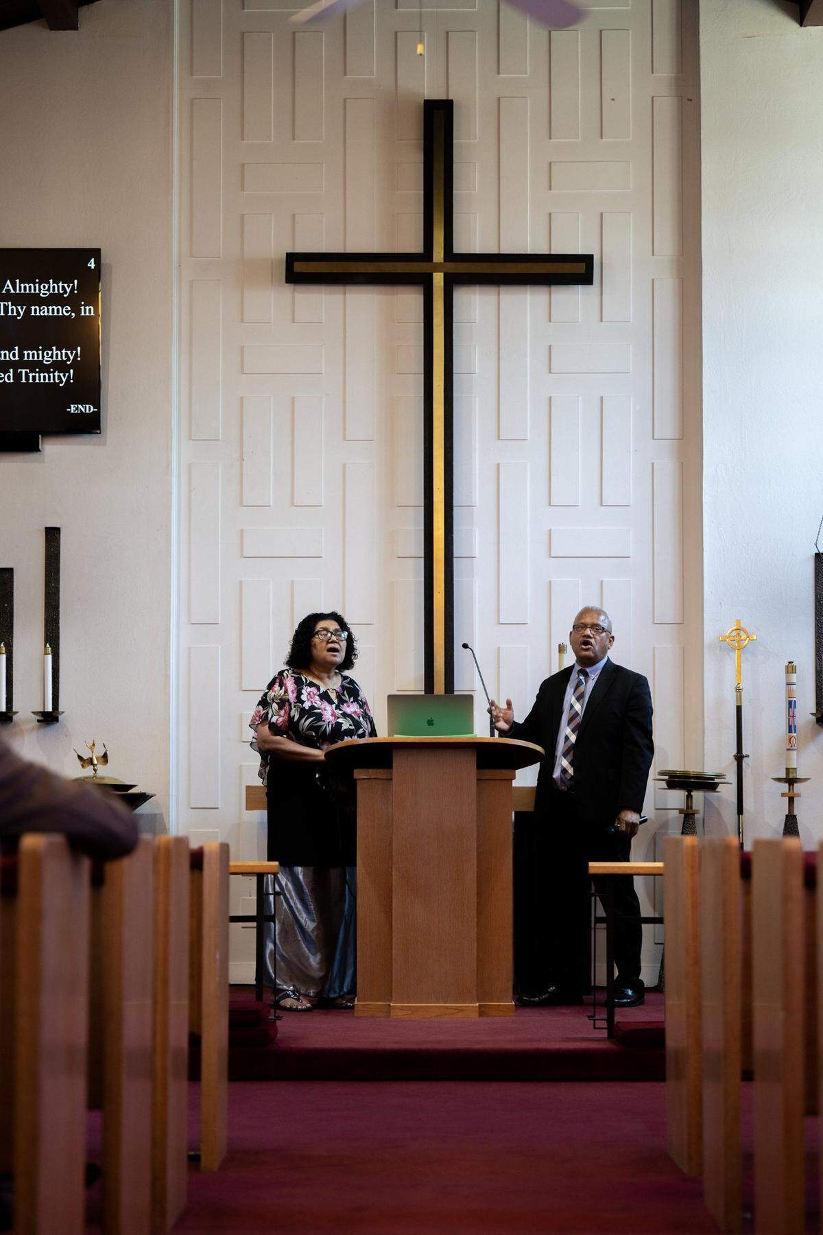 Sabbath school coordinator Sotia O’Conner, joined at the altar by her husband, Pastor Joseph O’Connor, sings a hymn at the Sacramento Fijian Seventh-Day Adventist Church service earlier this month in Carmichael.