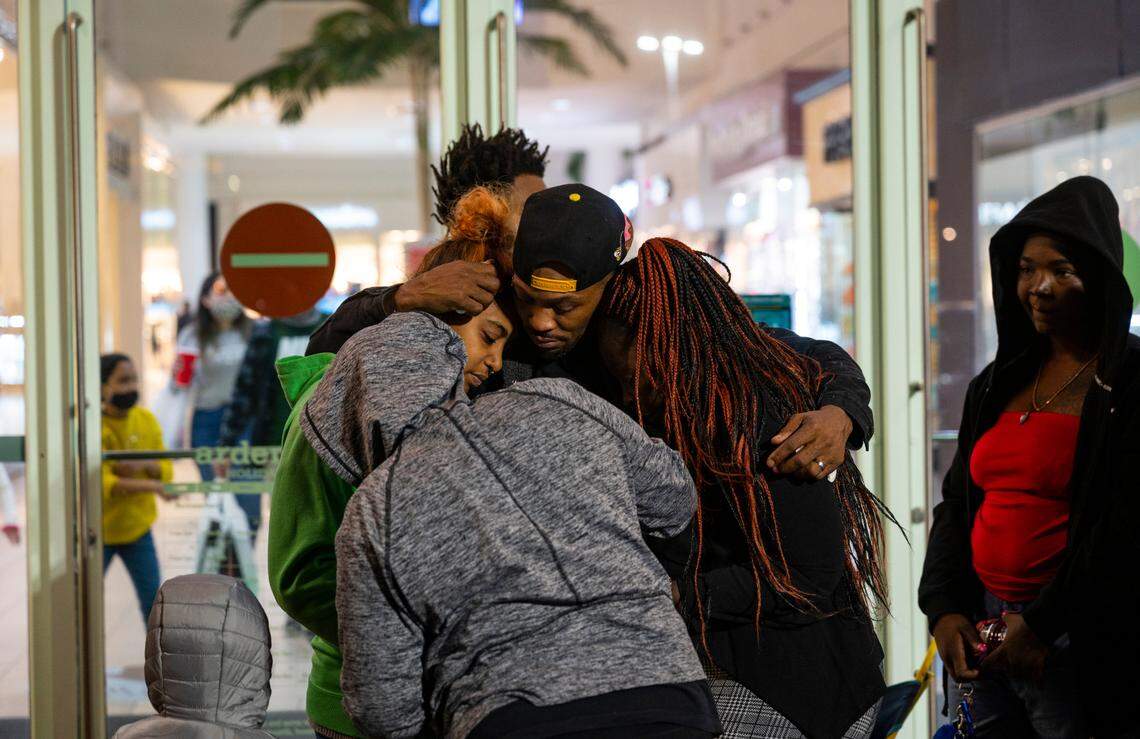 Family members of 19-year-old Dewayne James Jr. and 17-year-old Sa’Quan Reed-James grieve at a vigil at Arden Fair mall on Saturday, Nov. 28. The two teenage boys were fatally shot at the mall on Friday.