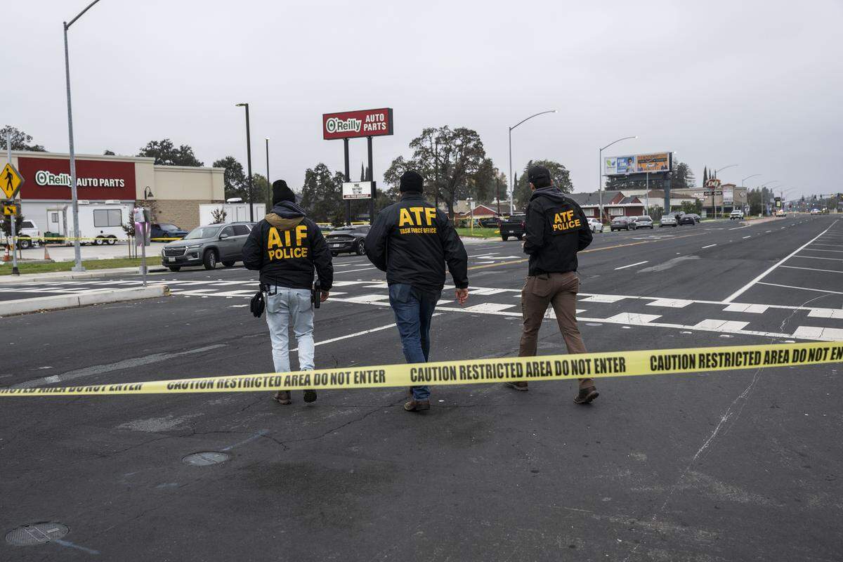 ATF officers walk on Sunday, Nov. 30, 2025, to the site of a mass shooting near Stockton the night before. Authorities said four were killed and 11 were injured in the shooting outside a child's birthday party.
