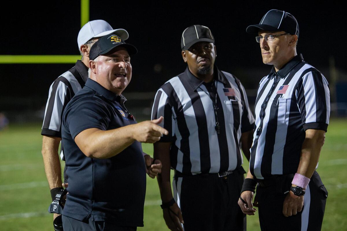 Sutter coach Ryan Reynolds argues a call with the referees during the game against the Center Cougars on Friday at Sutter High School. The Huskies won 23-20 in overtime.