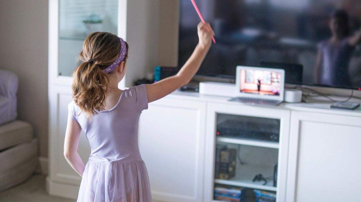 A young dancer learns ballet via an online class. Students are learning a lot of lessons that can’t be taught in books.