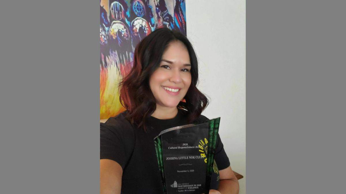 Joshina Little Nok Cluff, an advocate for American Indians and Alaska Natives in abusive relationships, holds the cultural responsiveness award she received from the California Partnership to End Domestic Violence.
