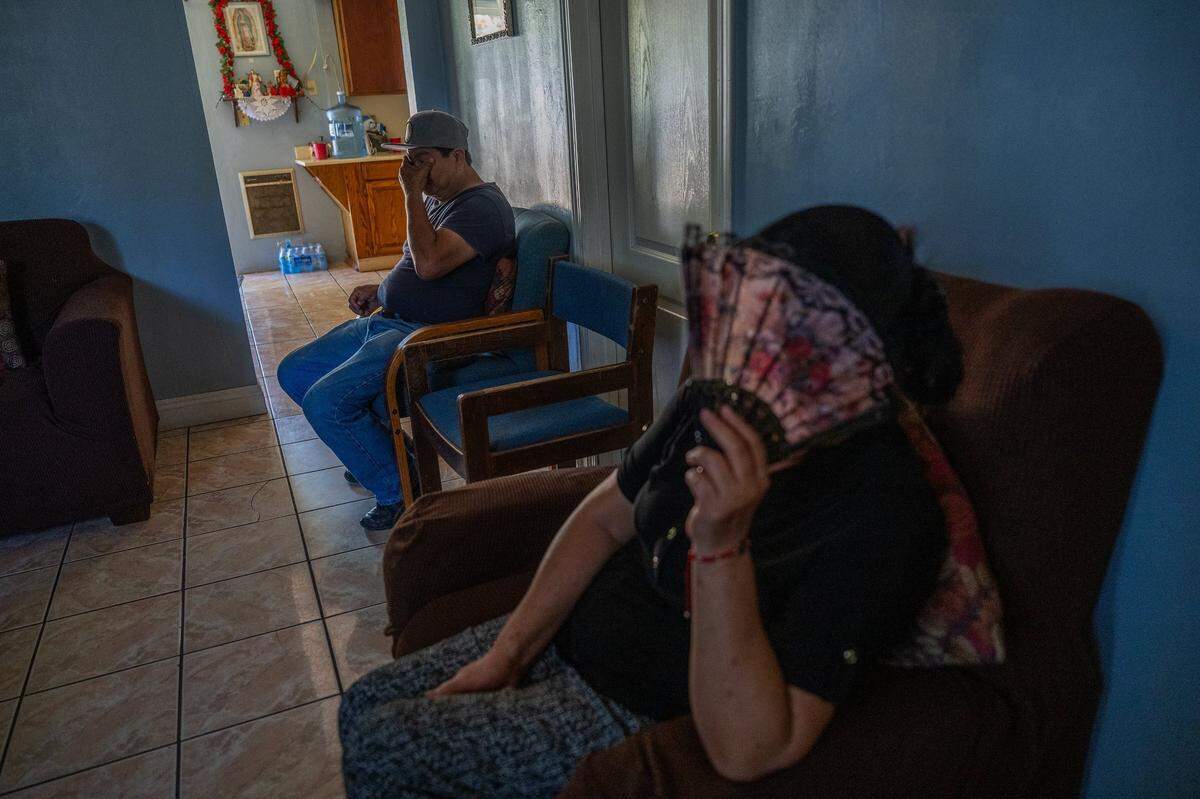 Maria Magaña uses a fan Tuesday as her husband Pedro talks about the stress they’ve endured from the debilitating heat because they could not afford air conditioning for their East Del Paso Heights home. Pedro said he hopes state and local agencies respond more aggressively to climate change and helping the working poor through it.