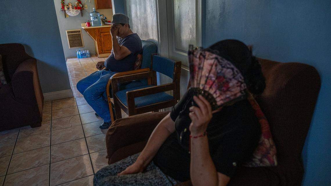 Maria Magaña uses a fan Tuesday as her husband Pedro talks about the stress they’ve endured from the debilitating heat because they could not afford air conditioning for their East Del Paso Heights home. Pedro said he hopes state and local agencies respond more aggressively to climate change and helping the working poor through it.